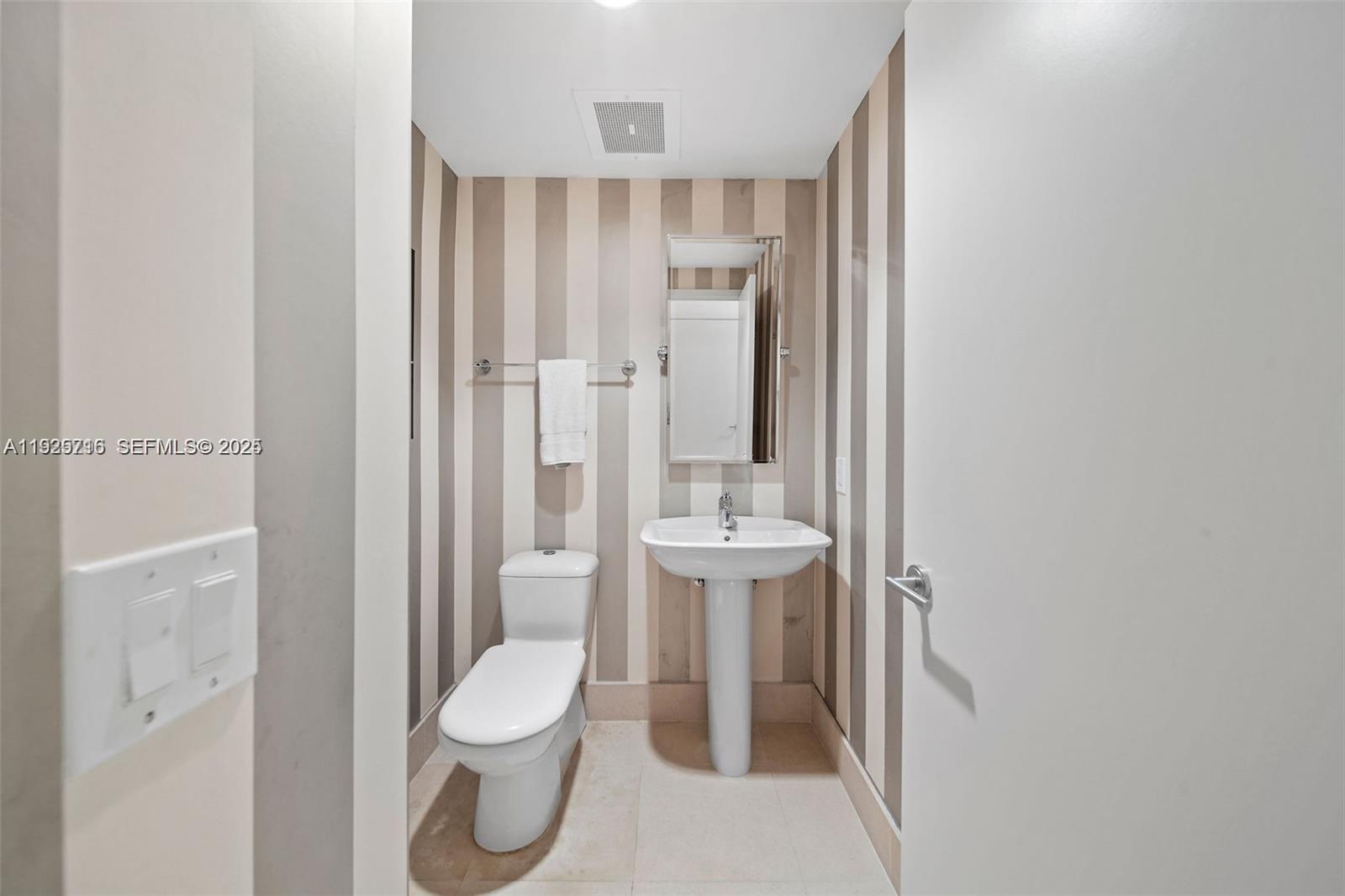 6899 Collins Avenue, Unit 1801 Miami Beach, FL 33141 - Photo 23 of 67 a bathroom with a toilet a sink and shower