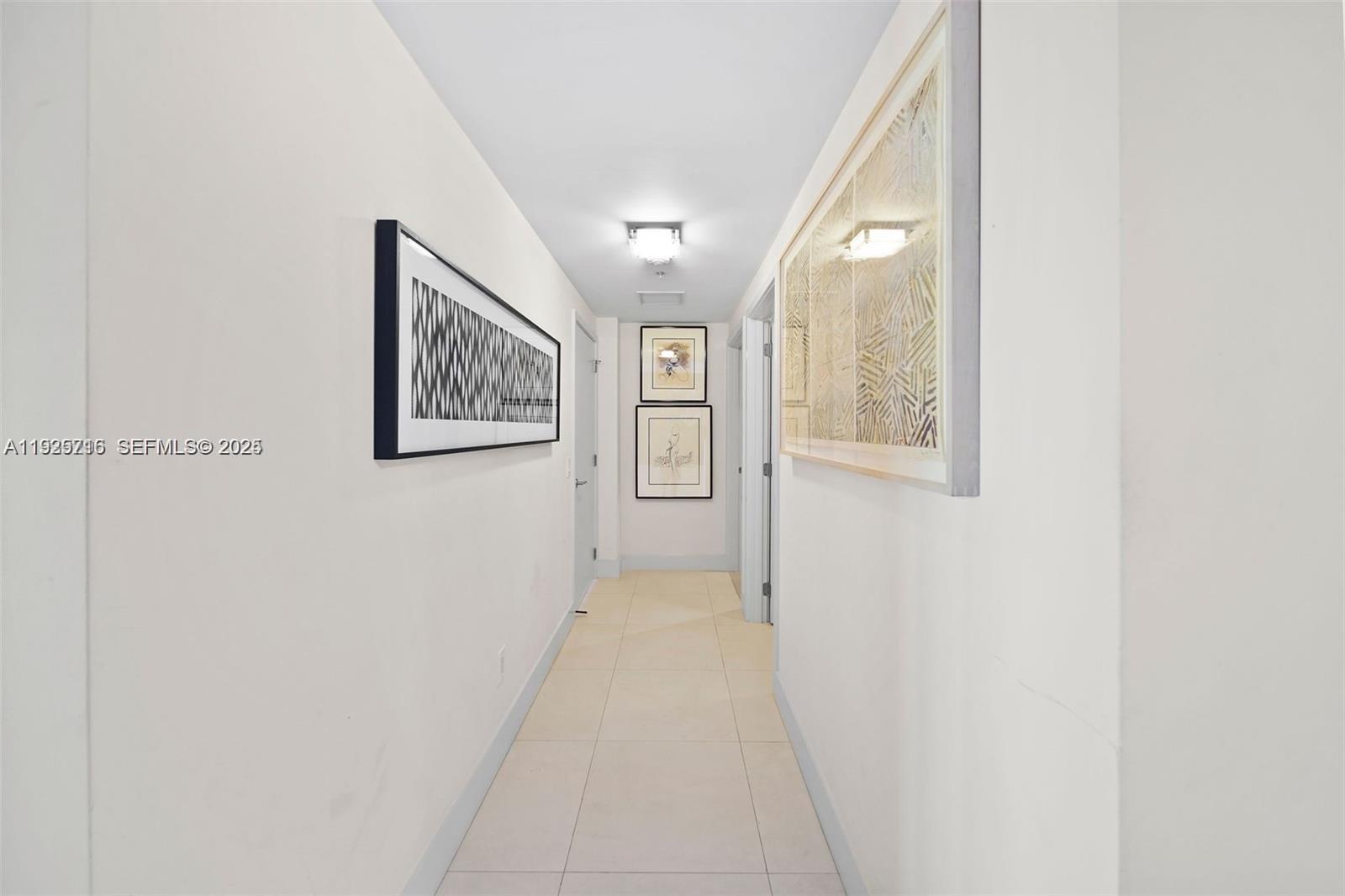 6899 Collins Avenue, Unit 1801 Miami Beach, FL 33141 - Photo 24 of 67 a view of a hallway with wooden floor