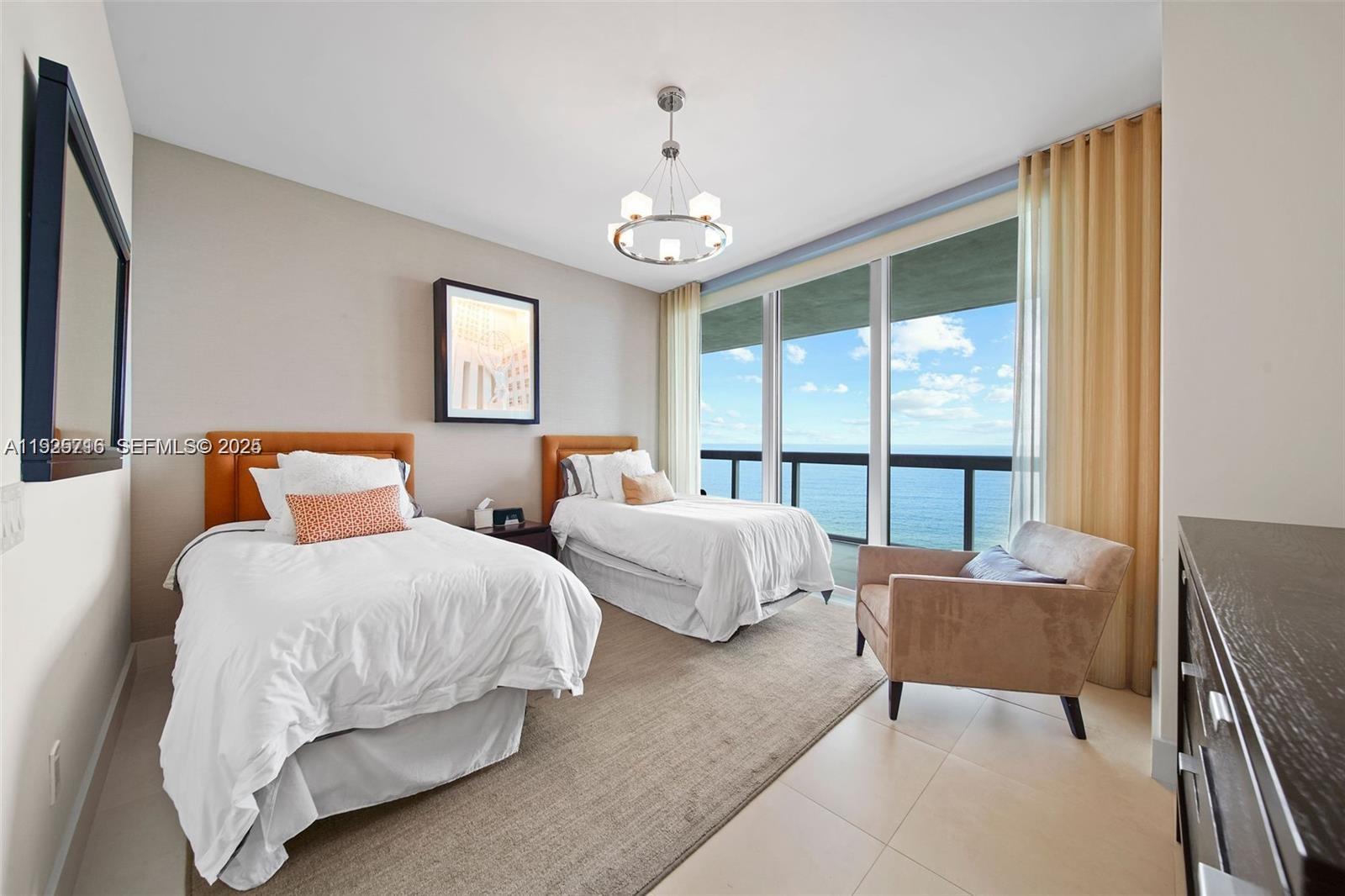 6899 Collins Avenue, Unit 1801 Miami Beach, FL 33141 - Photo 26 of 67 a bedroom with two beds and a large window