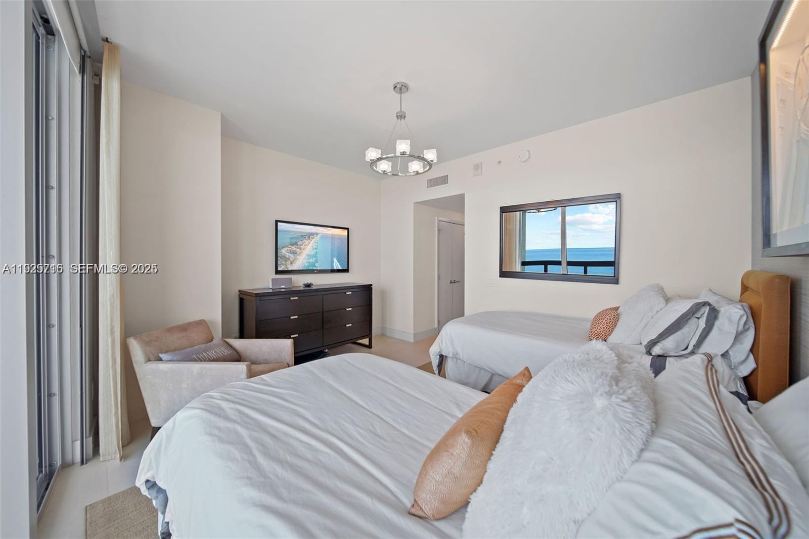 6899 Collins Avenue, Unit 1801 Miami Beach, FL 33141 - Photo 29 of 67 a bedroom with bed and a tv