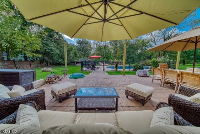 a view of a patio with couches and table under an umbrella