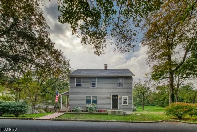 aerial view of a house with yard and sitting area