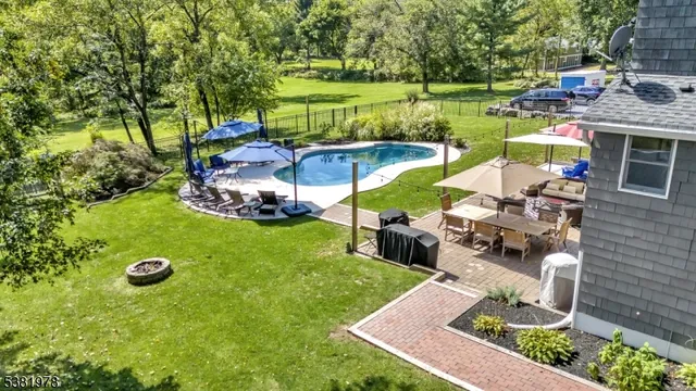 a aerial view of a house with a yard table and chairs