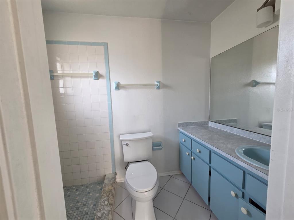 12200 Norvell Road Spring Hill, FL 34609 - Photo 12 of 16 a bathroom with a granite countertop toilet and a sink