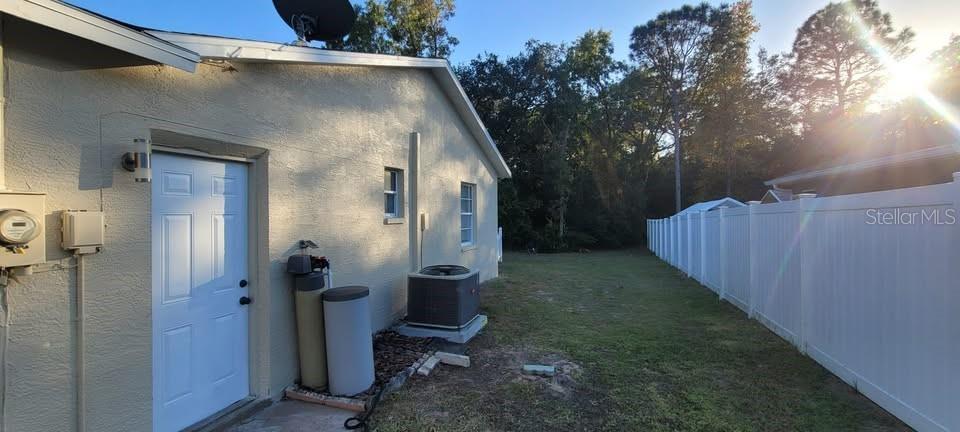 12200 Norvell Road Spring Hill, FL 34609 - Photo 16 of 16 a view of a small house with a yard and garage