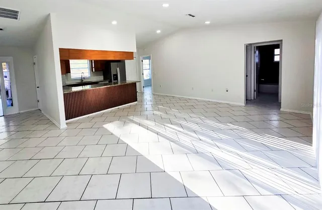 a view of kitchen with granite countertop cabinets and outdoor space