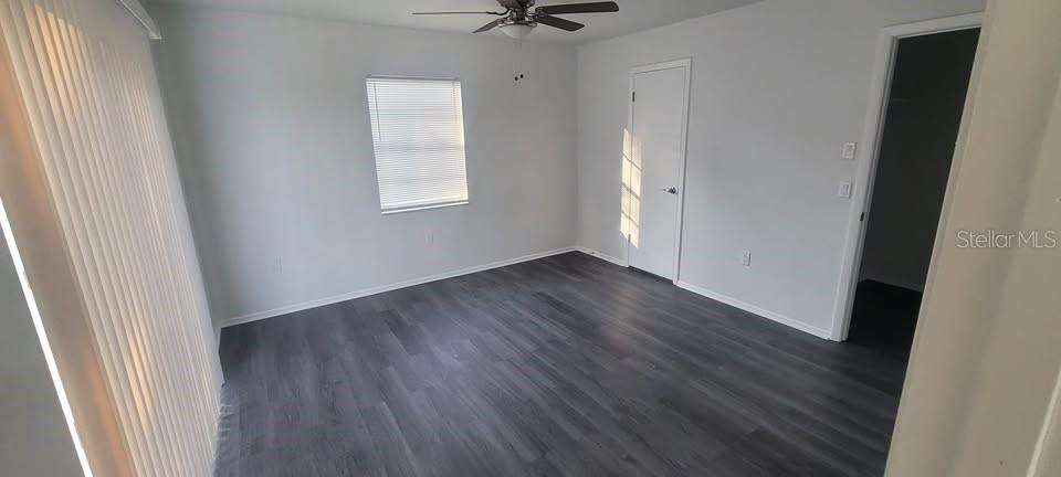 12200 Norvell Road Spring Hill, FL 34609 - Photo 9 of 16 an empty room with wooden floor and a window