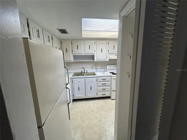 a utility room with cabinets washer and dryer