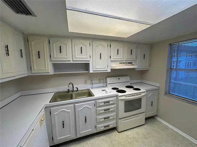 a kitchen with stainless steel appliances granite countertop a sink and cabinets