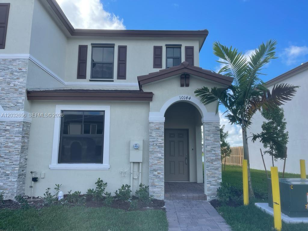 10144 Southwest 228th Terrace Miami, FL 33190 - Photo 2 of 23 a front view of a house with garden