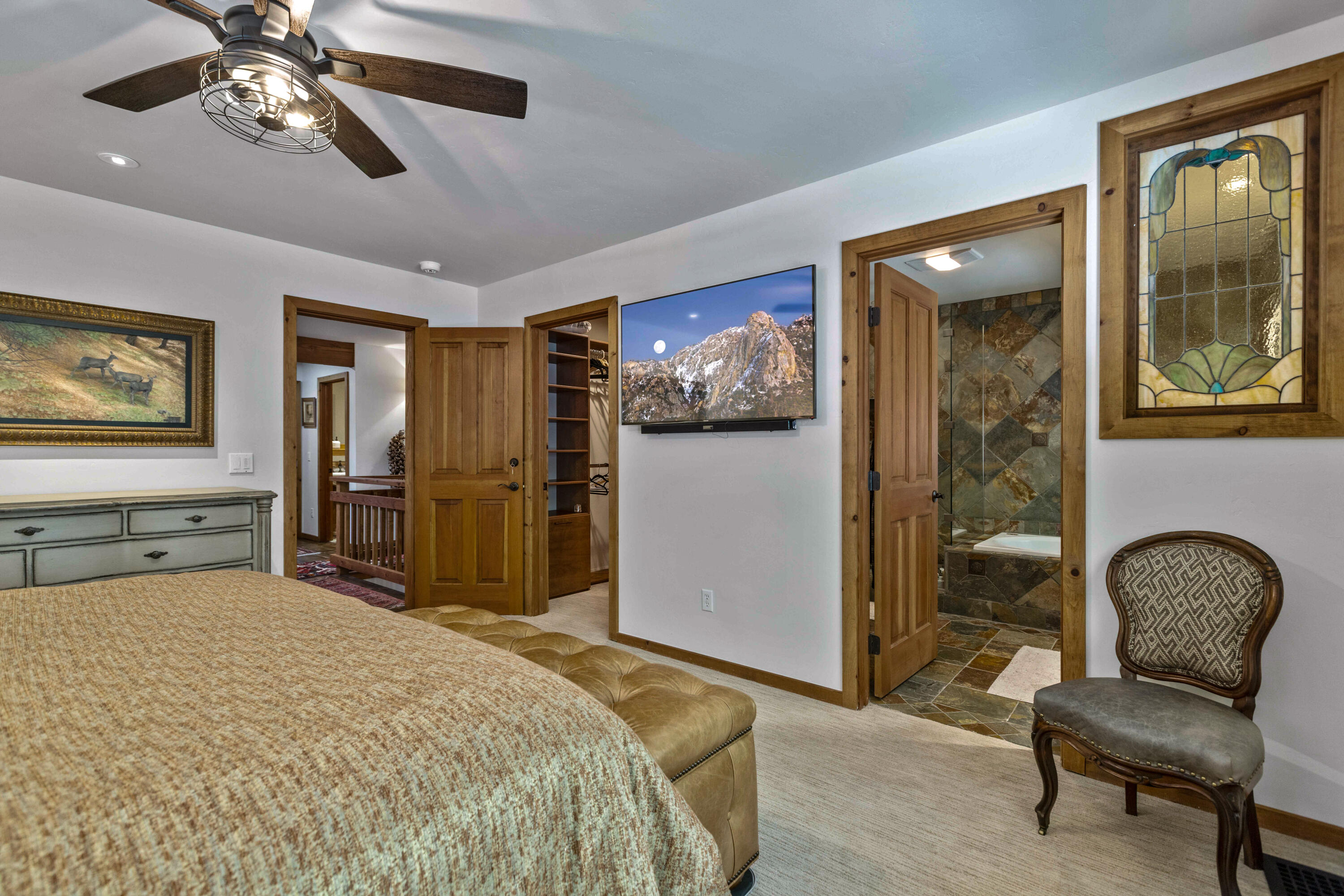 24581 Fern Valley Road Idyllwild, CA 92549 - Photo 20 of 45 a bedroom with a bed and a chair