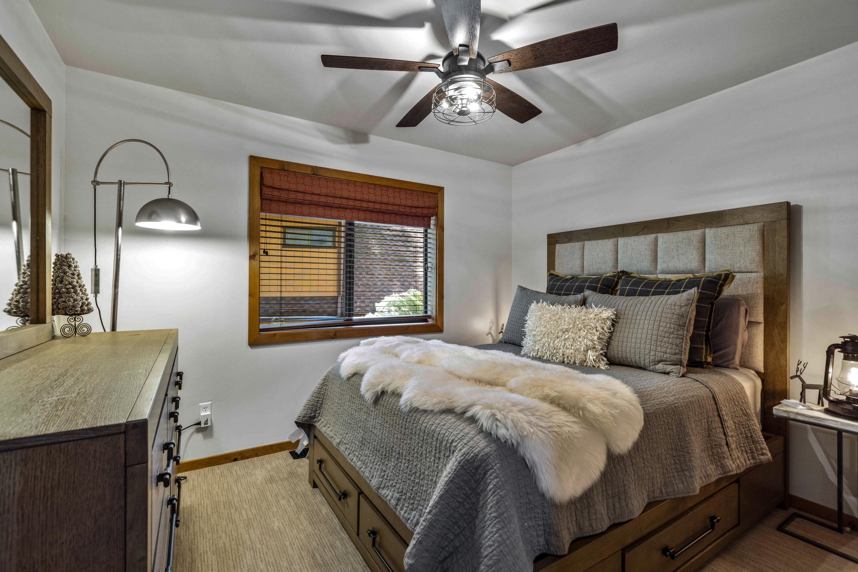 24581 Fern Valley Road Idyllwild, CA 92549 - Photo 22 of 45 a bedroom with a large bed and a chandelier