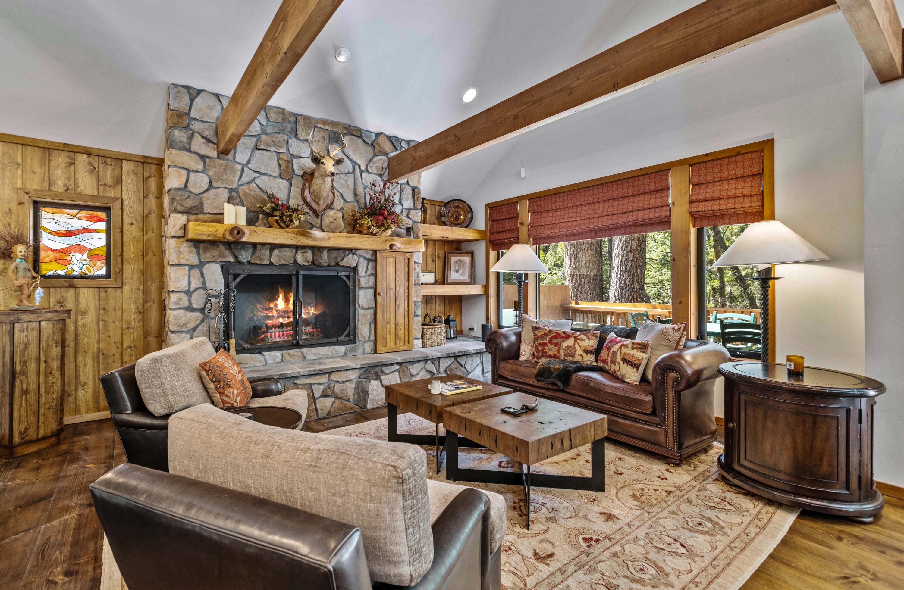 24581 Fern Valley Road Idyllwild, CA 92549 - Photo 9 of 45 a living room with furniture a large window and a fireplace