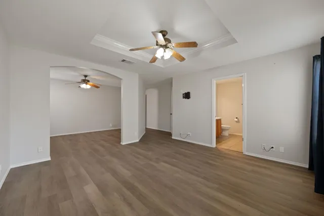 a view of an empty room with wooden floor