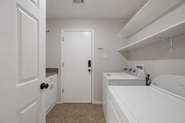 a view of a patio with chairs and plants