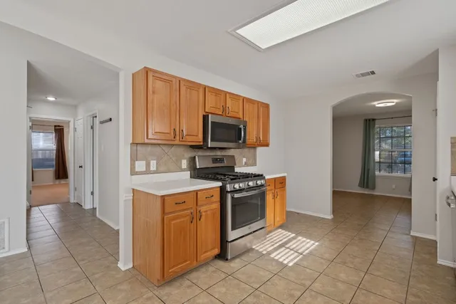 a kitchen with stainless steel appliances granite countertop a stove and a sink