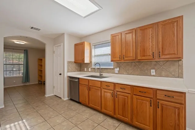 a kitchen with stainless steel appliances granite countertop a sink and cabinets
