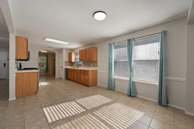a room with a bed and a view of kitchen