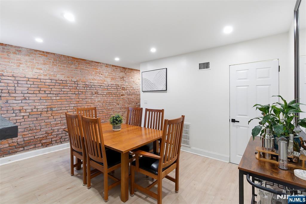 22 8th Avenue Newark, NJ 07104 - Photo 12 of 26 a dining room with furniture and potted plants