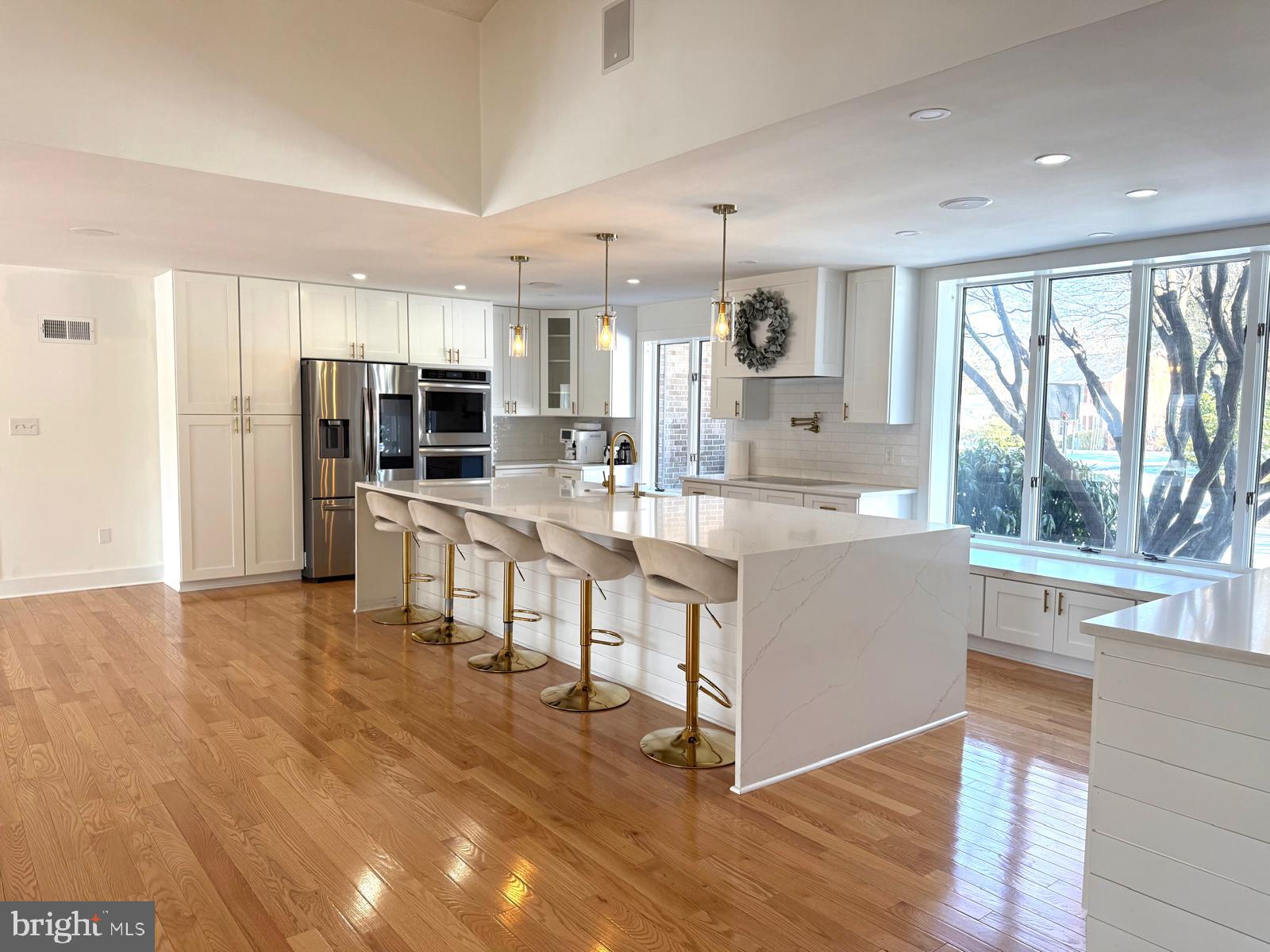 8104 Overlook Court Frederick, MD 21702 - Photo 3 of 12 a large white kitchen with a large window and stainless steel appliances