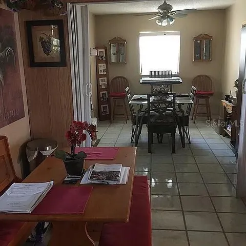 a dining room with furniture and window