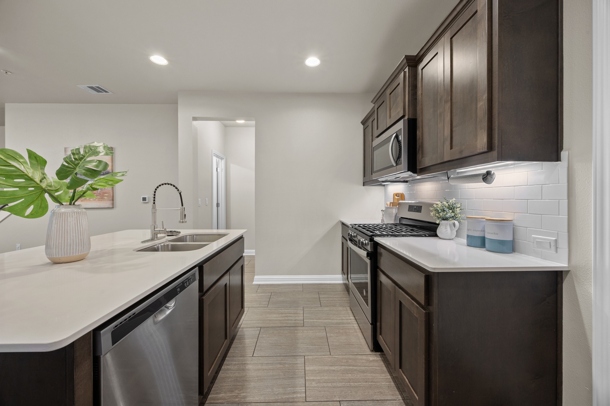 6814 East Riverside Drive, Unit 104 Austin, TX 78741 - Photo 15 of 37 a kitchen with stainless steel appliances granite countertop a sink a stove and a refrigerator