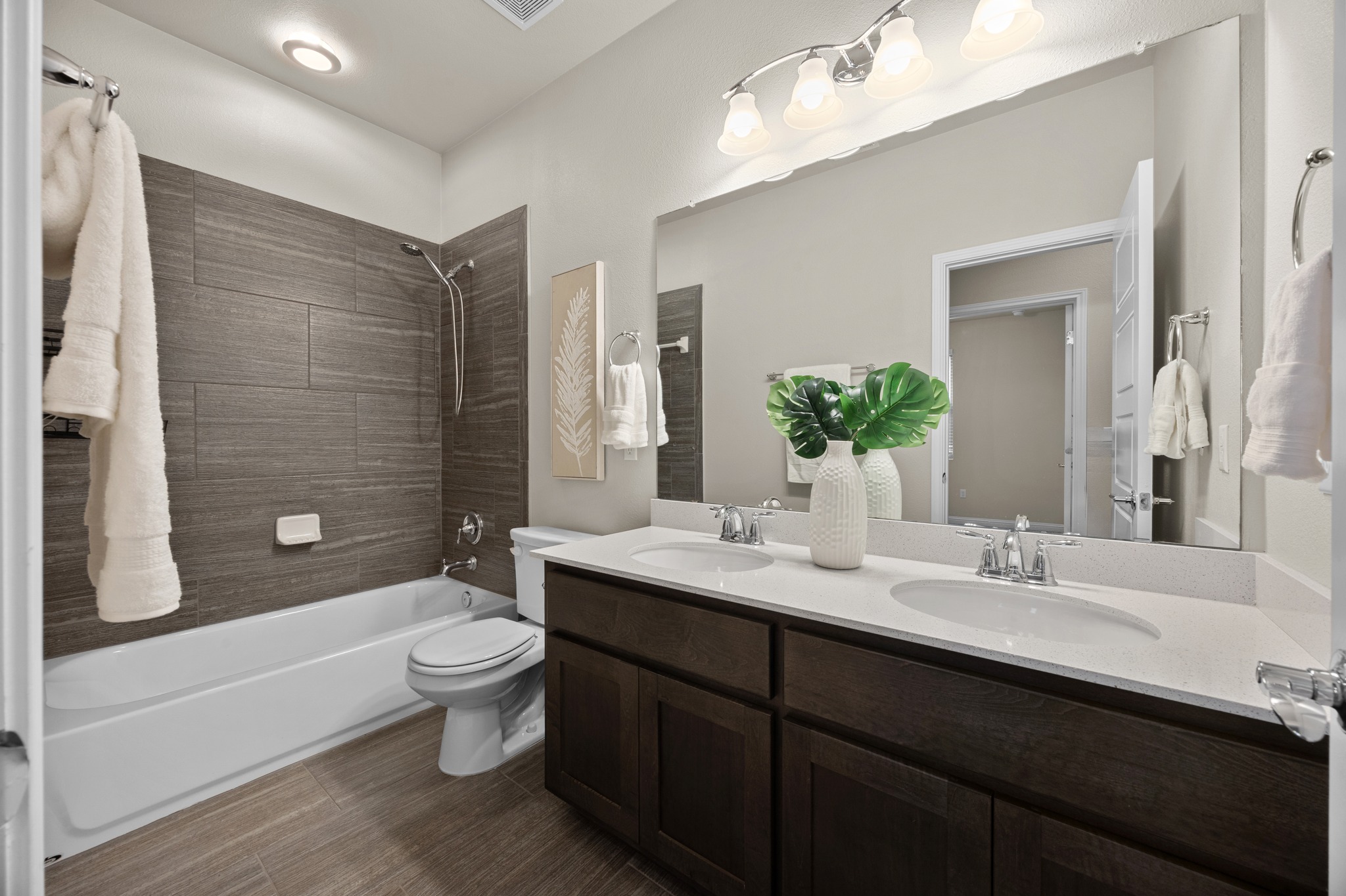 6814 East Riverside Drive, Unit 104 Austin, TX 78741 - Photo 30 of 37 a bathroom with a double vanity sink toilet and shower