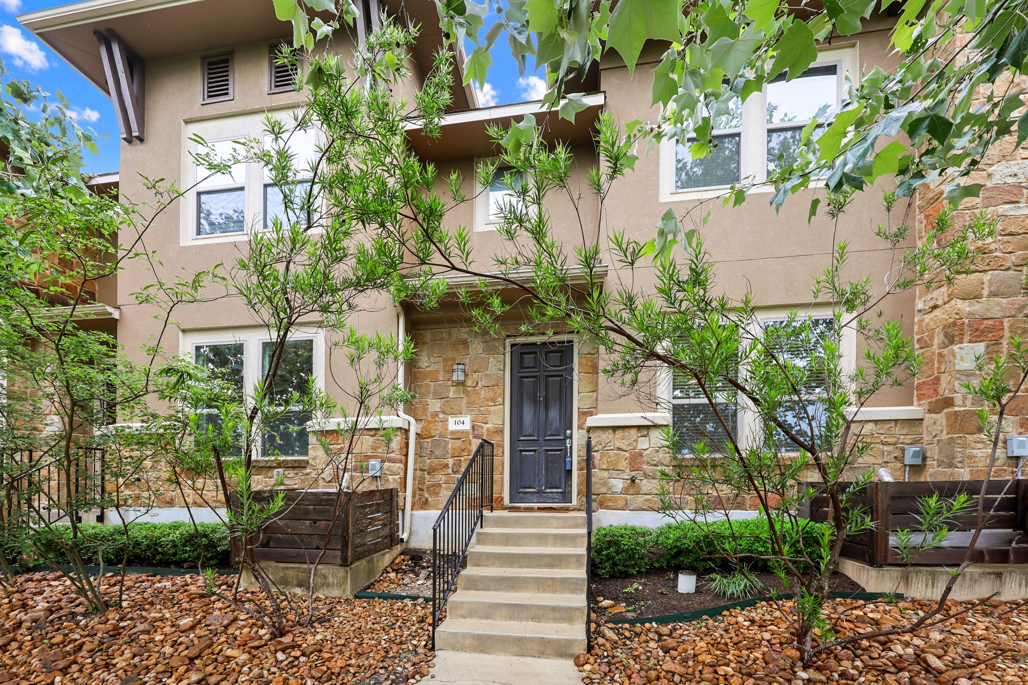 6814 East Riverside Drive, Unit 104 Austin, TX 78741 - Photo 3 of 37 a front view of a house with a fountain