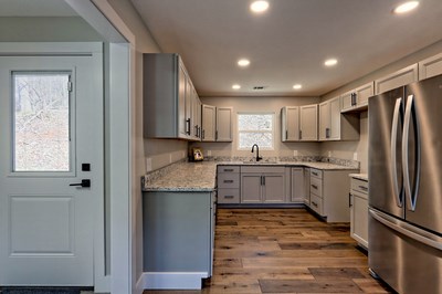 750 Sunnyside Road Hiawassee, GA 30546 - Photo 15 of 46 a kitchen with a refrigerator sink and cabinets