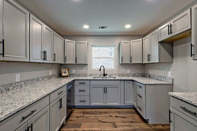 750 Sunnyside Road Hiawassee, GA 30546 - Photo 16 of 46 a kitchen with stainless steel appliances granite countertop a sink and dishwasher a stove top oven with white cabinets