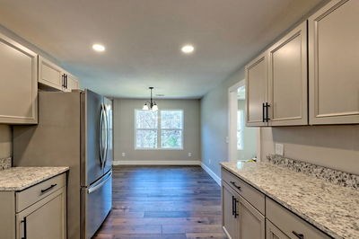 750 Sunnyside Road Hiawassee, GA 30546 - Photo 18 of 46 a kitchen with granite countertop stainless steel appliances and wooden cabinets