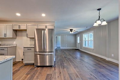 750 Sunnyside Road Hiawassee, GA 30546 - Photo 24 of 46 a kitchen with stainless steel appliances granite countertop a refrigerator a sink dishwasher a stove and white countertops with wooden floor
