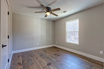 750 Sunnyside Road Hiawassee, GA 30546 - Photo 26 of 46 an empty room with wooden floor fan and windows