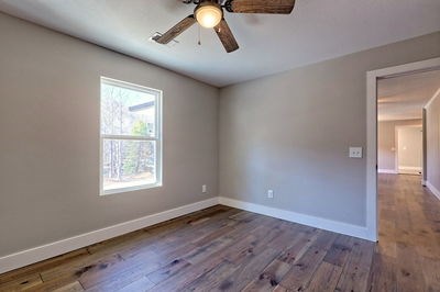750 Sunnyside Road Hiawassee, GA 30546 - Photo 28 of 46 a view of an empty room with wooden floor and a window