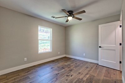 750 Sunnyside Road Hiawassee, GA 30546 - Photo 30 of 46 a view of an empty room with wooden floor and a window