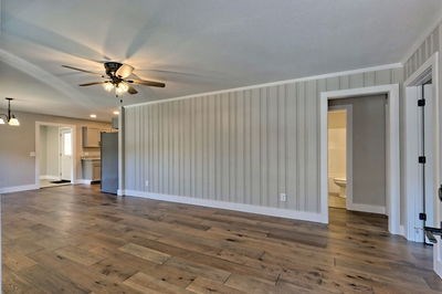 750 Sunnyside Road Hiawassee, GA 30546 - Photo 10 of 46 an empty room with wooden floor and ceiling fan