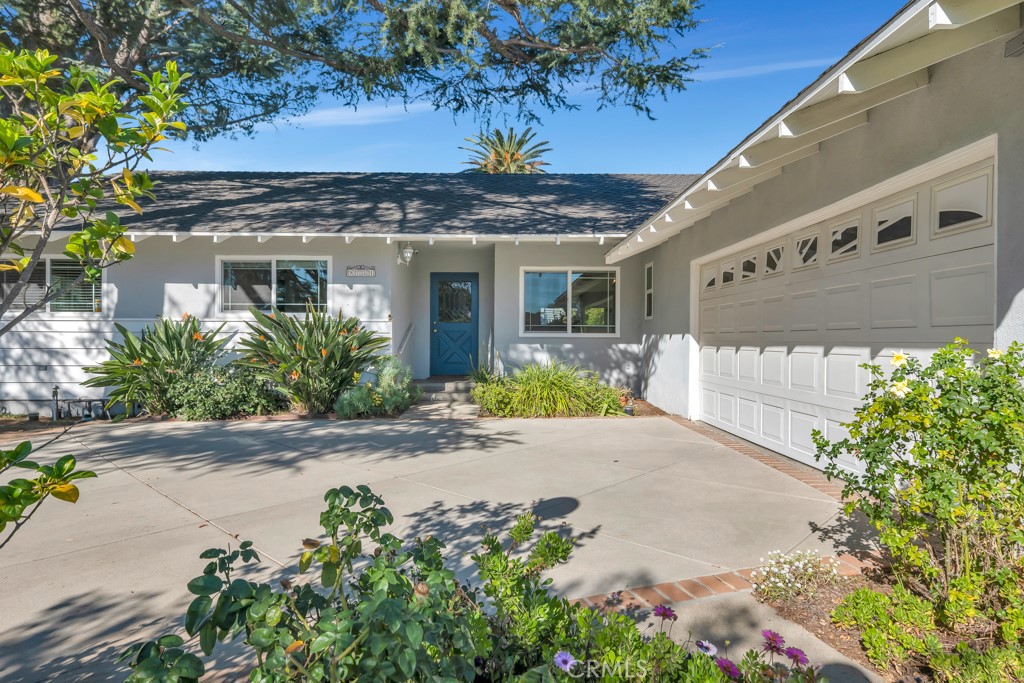 9731 Rathburn Avenue Northridge, CA 91325 - Photo 1 of 1 a front view of a house with a yard and potted plants