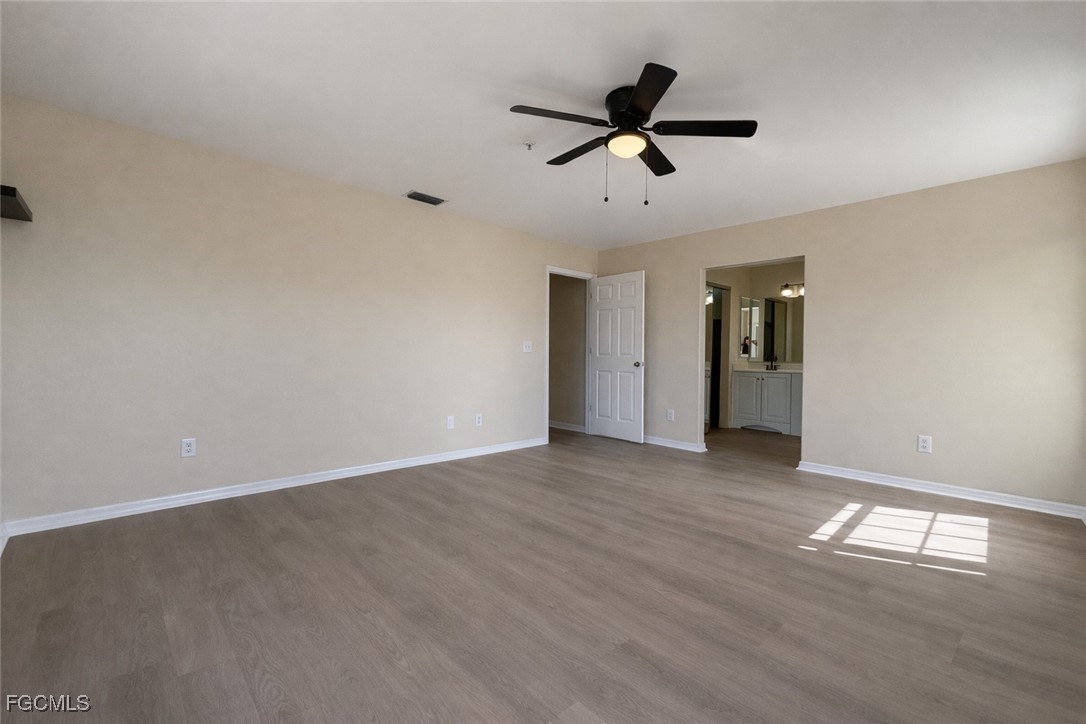 5390 Park Road, Unit 3 Fort Myers, FL 33908 - Photo 12 of 26 a view of a livingroom with a ceiling fan and wooden floor