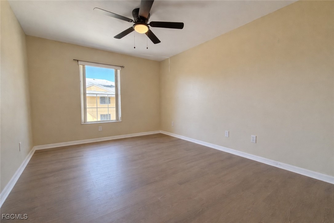 5390 Park Road, Unit 3 Fort Myers, FL 33908 - Photo 21 of 26 an empty room with windows and fan