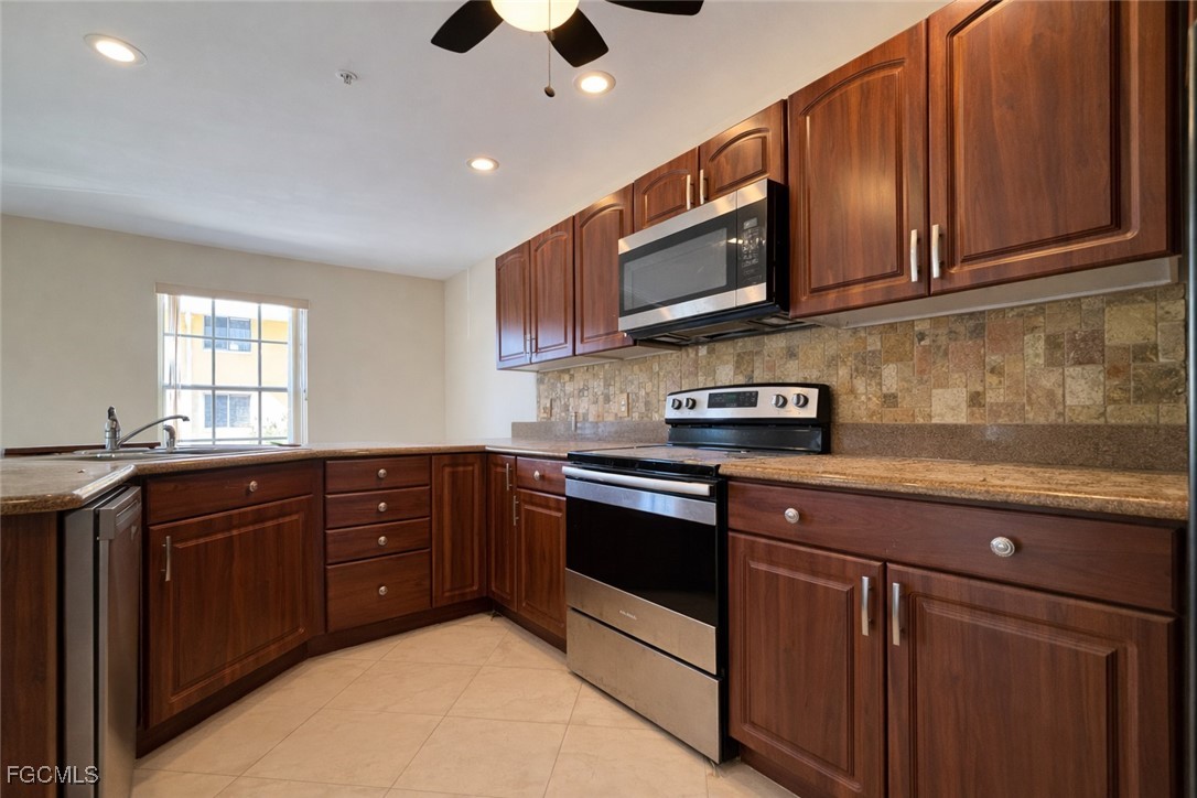 5390 Park Road, Unit 3 Fort Myers, FL 33908 - Photo 6 of 26 a kitchen with stainless steel appliances granite countertop a sink and a stove top oven