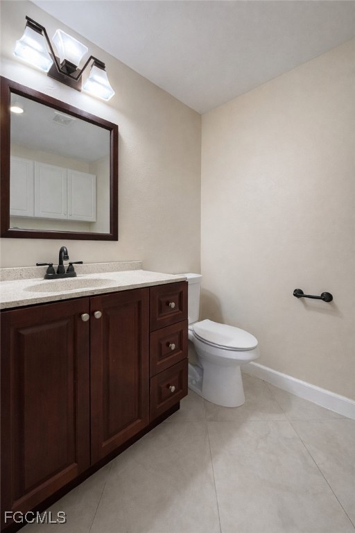 5390 Park Road, Unit 3 Fort Myers, FL 33908 - Photo 8 of 26 a bathroom with a toilet a sink and mirror