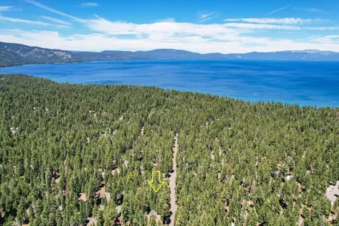 a view of a large yard with wooden fence