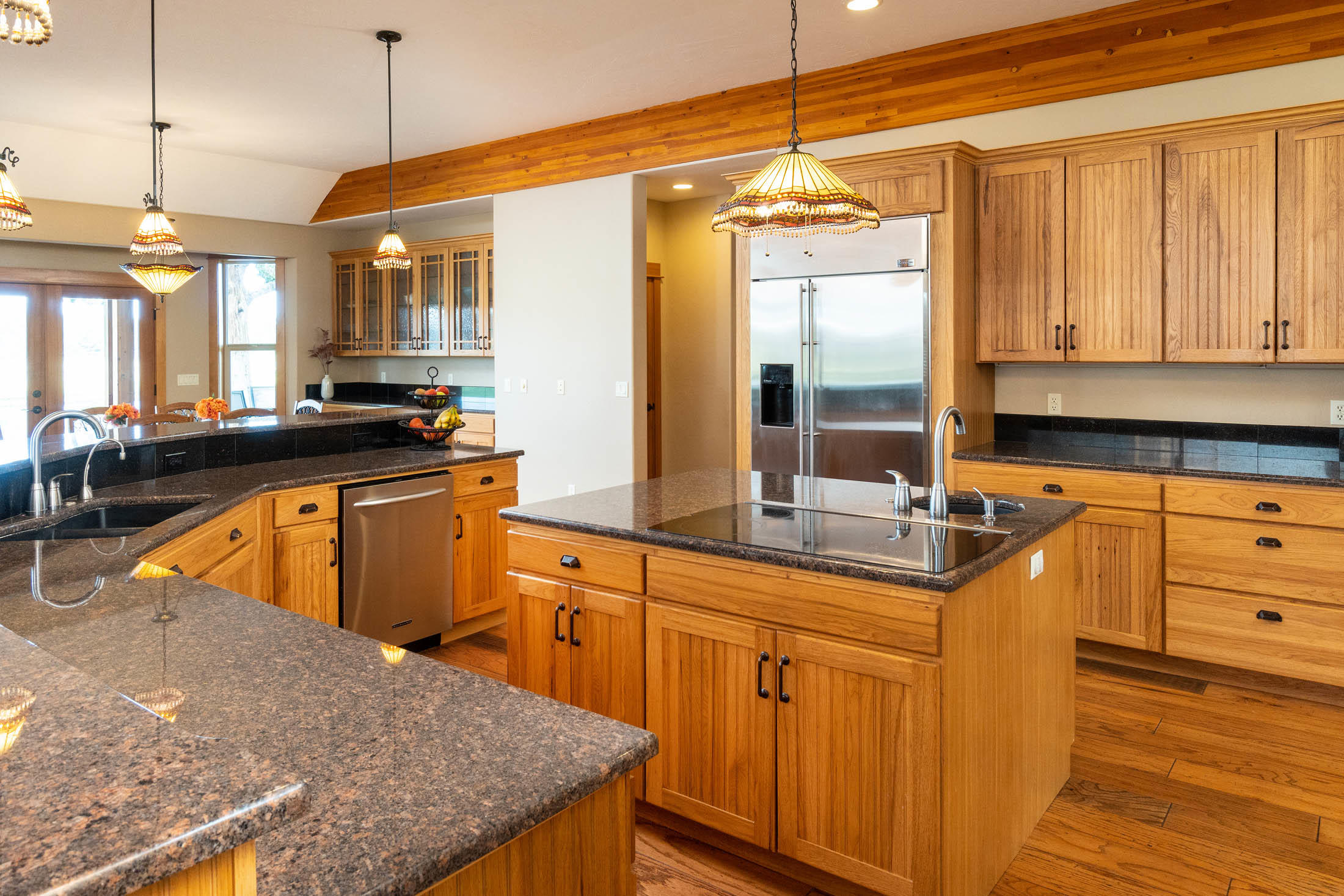 63575 Cricketwood Road Bend, OR 97701 - Photo 8 of 53 a kitchen with kitchen island granite countertop a sink a counter top space appliances and cabinets