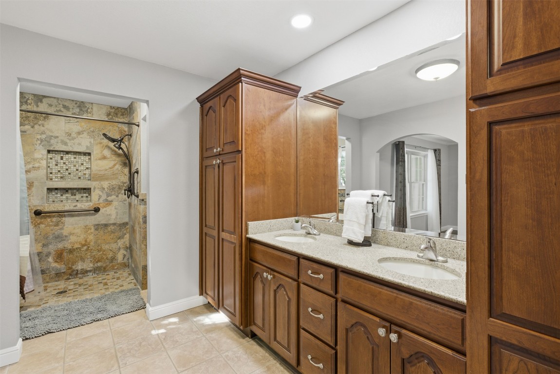 1600 East Messick Loop Round Rock, TX 78681 - Photo 5 of 38 The remodeled primary bathroom has large walk in shower and dual vanities with ample storage. The cabinets contain pull-out shelving!