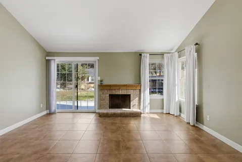 an empty room with furniture and a fireplace
