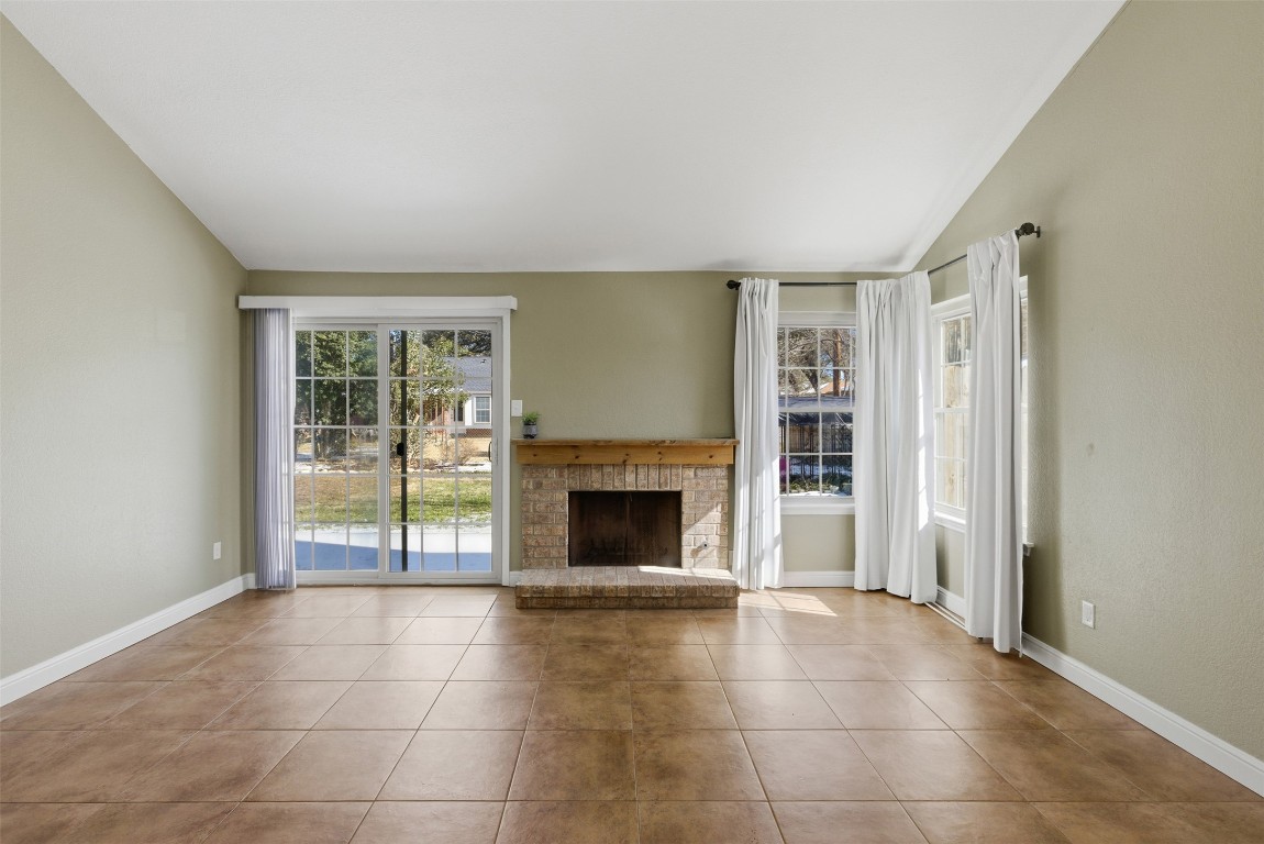1600 East Messick Loop Round Rock, TX 78681 - Photo 10 of 38 The family room, approximately 17x14'3" has several walls for TVs or artwork. Here you see the new windows and sliding door that surround the fireplace.