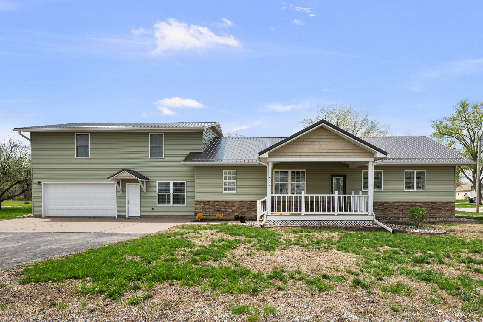 317 South Walnut Street Wilton, IA 52778 - Photo 1 of 45 a front view of a house with garden