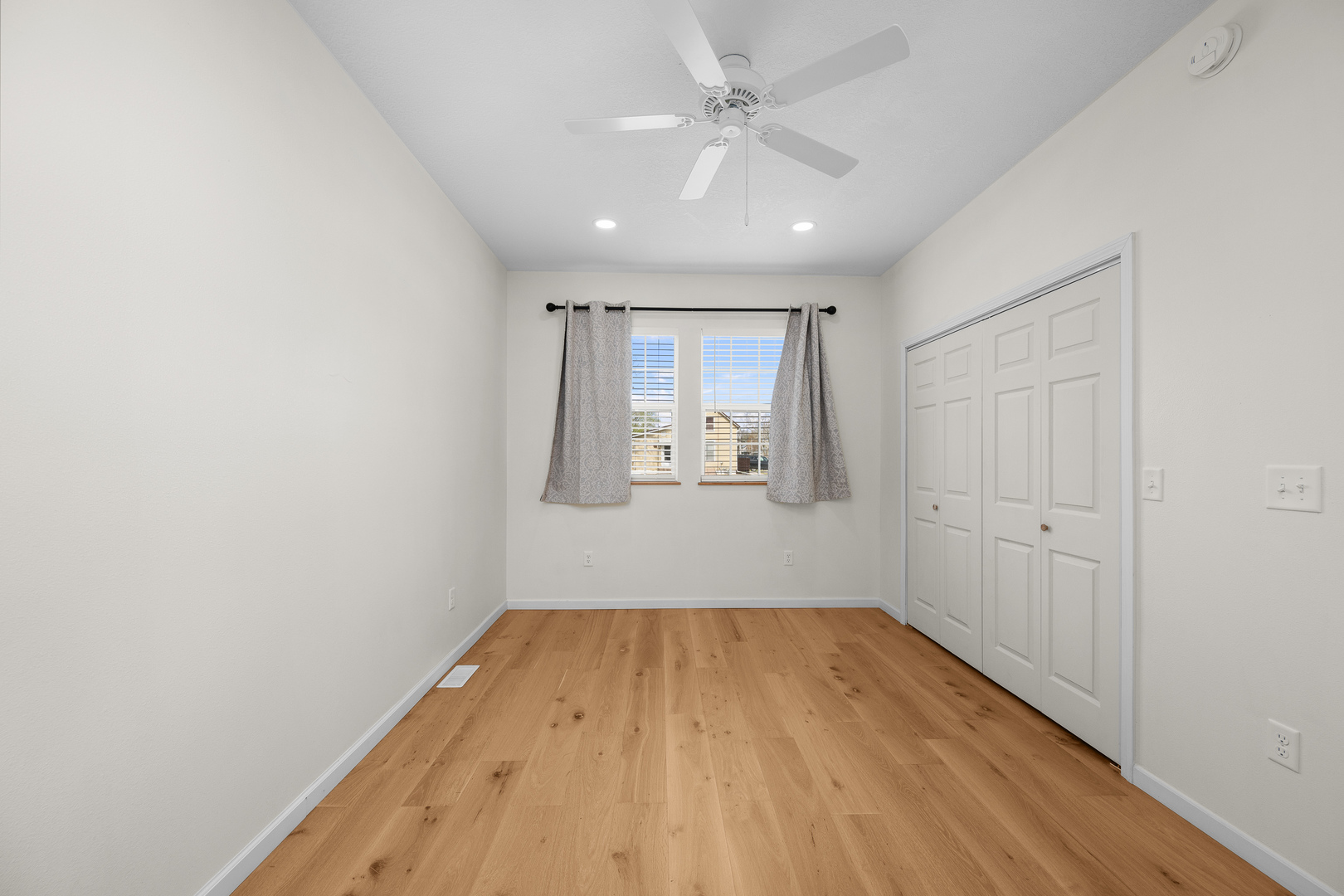 317 South Walnut Street Wilton, IA 52778 - Photo 18 of 45 a view of a room with wooden floor and ceiling fan