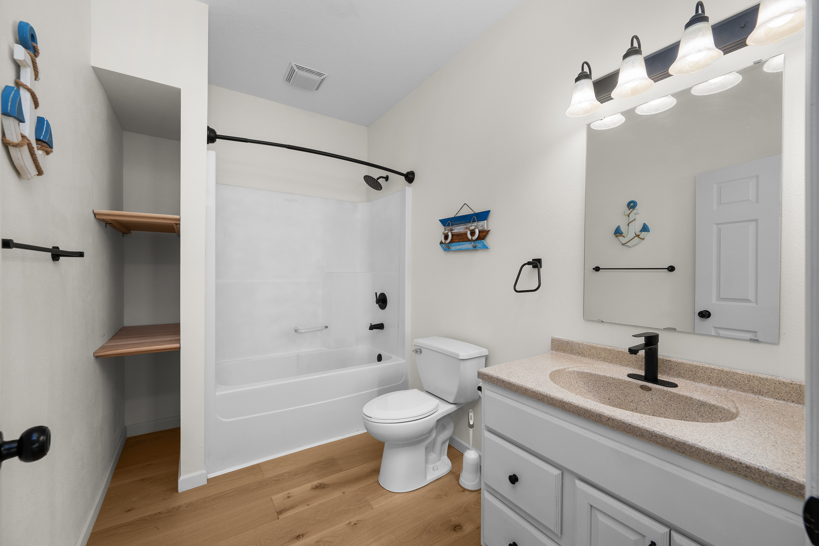 317 South Walnut Street Wilton, IA 52778 - Photo 21 of 45 a bathroom with a granite countertop sink a toilet and a bathtub