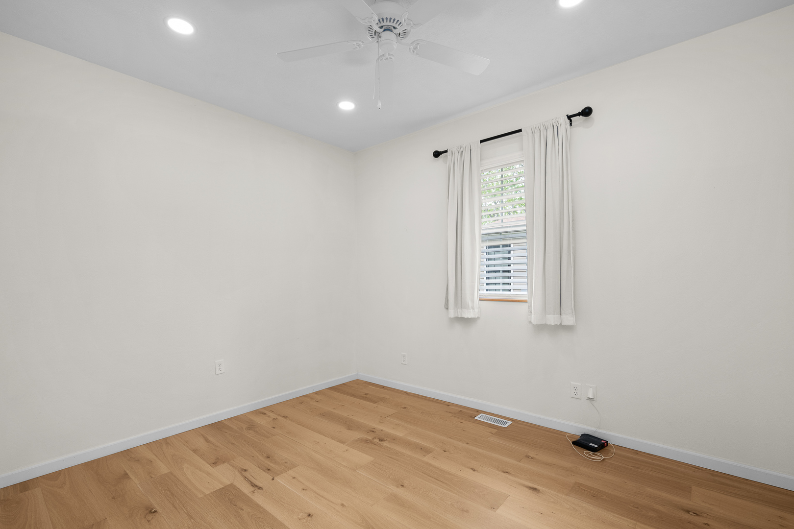 317 South Walnut Street Wilton, IA 52778 - Photo 23 of 45 a view of an empty room with wooden floor and a window